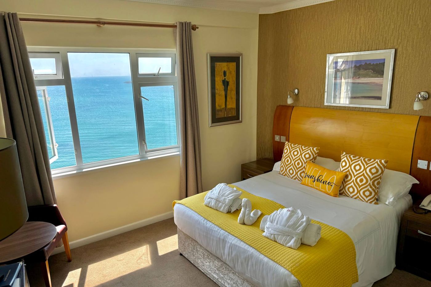 A full sea view bedroom at Marina Metro Hotel, with the window looking directly out across the bay at Havre des Pas