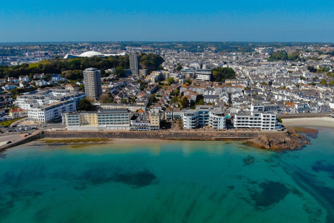 The Havre des Pas seafront in St Helier, Jersey, seen from the sea, with Marina Metro Hotel among the buildings along the promenade
