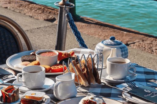 Breakfast laid out on the alfresco terrace at Marina Metro Hotel, on the Havre des Pas promenade beside the sea wall